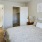 a bedroom with a bed and a lamp